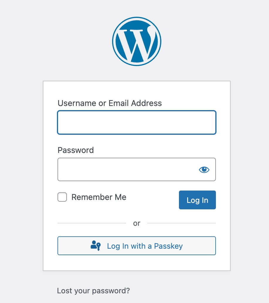 A WordPress login form showing the usual username and password fields with a Log In with a Passkey button below them, offering passwordless sign-in as an alternative.